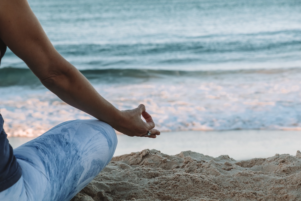 Person doing beach yoga