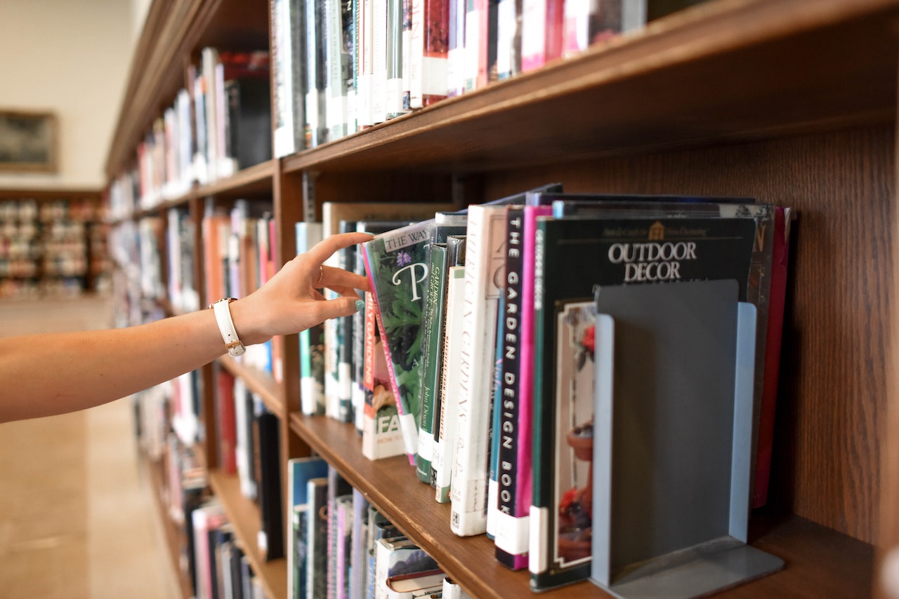 A person choosing a book in store