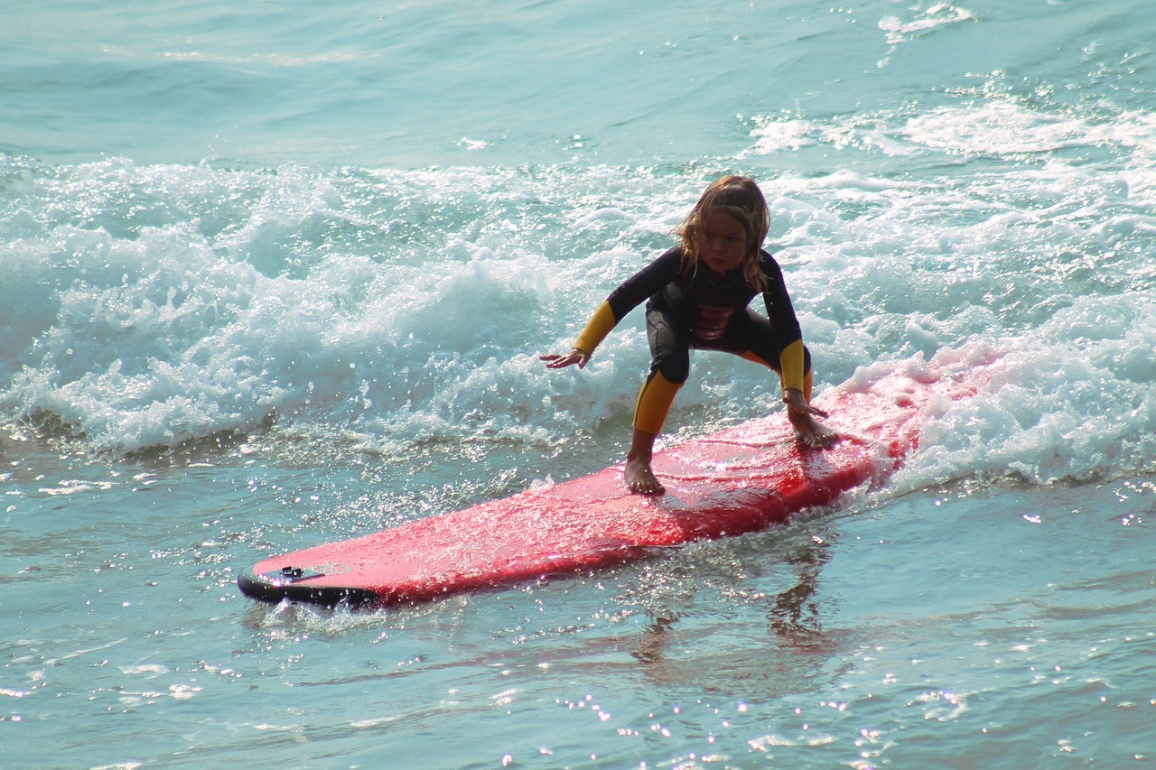 Kid surfing on the beach