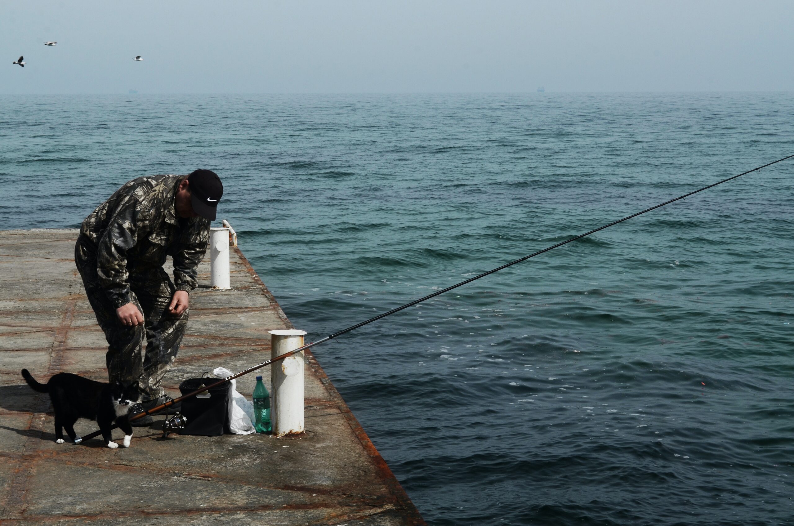 A man fishing on a pier on Hatteras Island