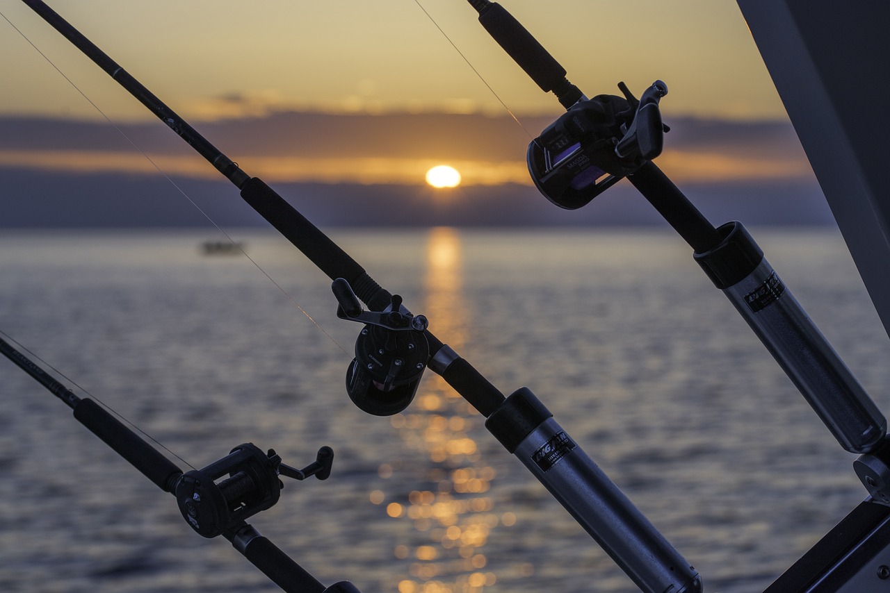 Three rods hanging off the side of a Hatteras fishing charter